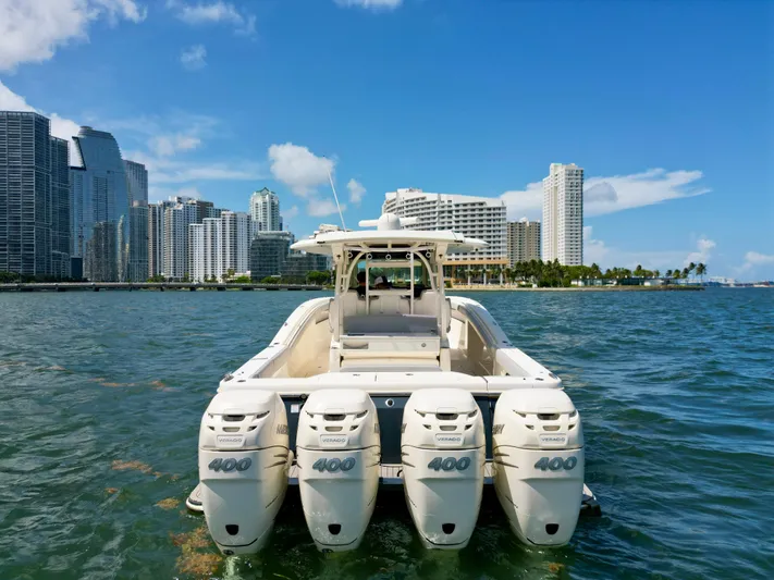  Yacht Photos Pics 2021 Scout 380 LXF boat with four engines, city skyline in background.