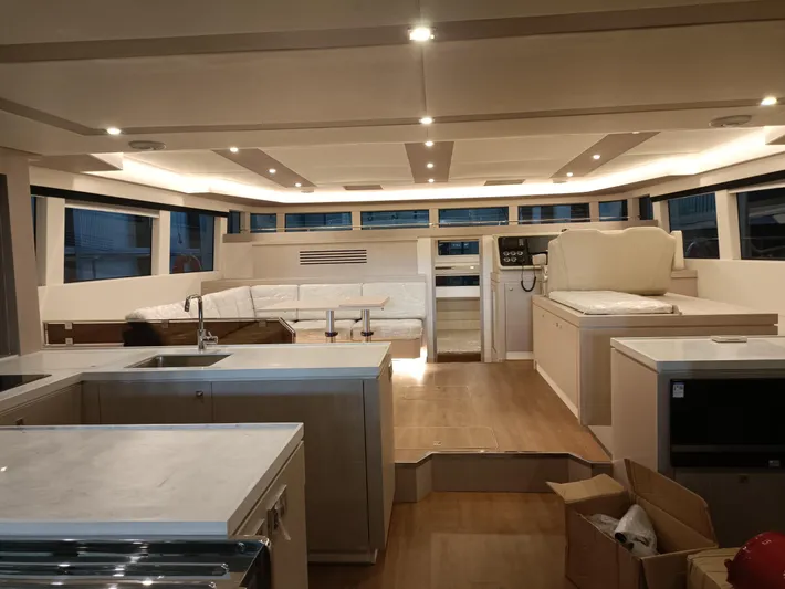  Yacht Photos Pics Luxurious interior of 2022 Mazarin 55 Catamaran, featuring modern kitchen and spacious seating area.