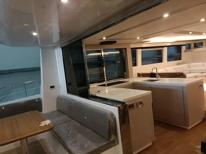  Yacht Photos Pics Luxurious interior of 2022 Mazarin 55 Catamaran, featuring modern kitchen and seating area.