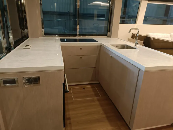  Yacht Photos Pics Modern kitchen interior on 2022 Mazarin 55 Catamaran, featuring sleek countertops and ample storage.
