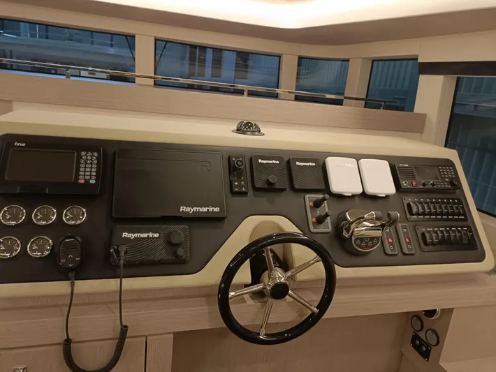  Yacht Photos Pics Control panel of 2022 Mazarin 55 Catamaran Diesel with navigation instruments and steering wheel.