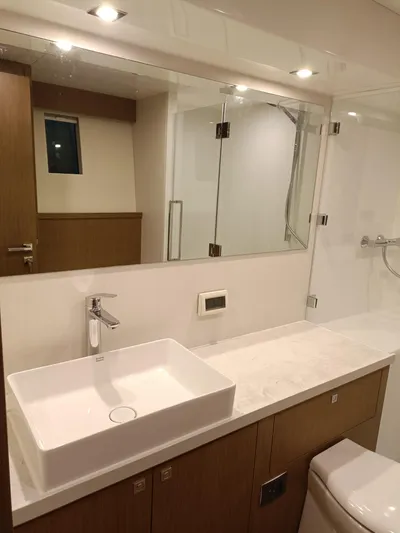  Yacht Photos Pics Modern bathroom in 2022 Mazarin 55 Catamaran with sleek fixtures and spacious design.