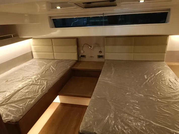  Yacht Photos Pics Interior of 2022 Mazarin 55 Catamaran with twin beds and modern lighting.