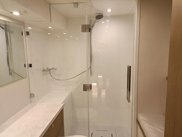  Yacht Photos Pics Luxurious bathroom in 2022 Mazarin 55 Catamaran, featuring modern shower and sleek design.