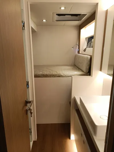  Yacht Photos Pics 2022 Mazarin 55 Catamaran interior with cozy bed and modern bathroom.