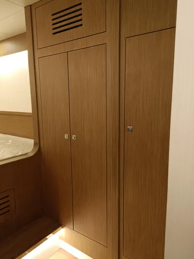  Yacht Photos Pics 2022 Mazarin 55 Catamaran interior with wooden cabinetry and modern design.