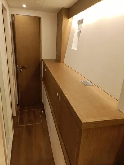  Yacht Photos Pics Interior hallway of 2022 Mazarin 55 Catamaran, featuring sleek wood finishes and modern design.