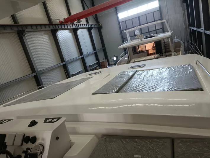  Yacht Photos Pics 2022 Mazarin 55 Catamaran Diesel in a warehouse, showcasing sleek design and modern features.