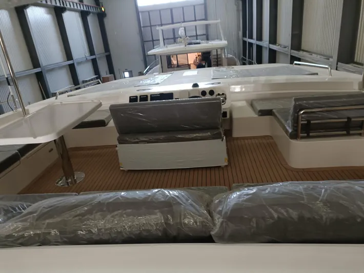  Yacht Photos Pics 2022 Mazarin 55 Catamaran Diesel interior with modern seating and control panel in a spacious setting.