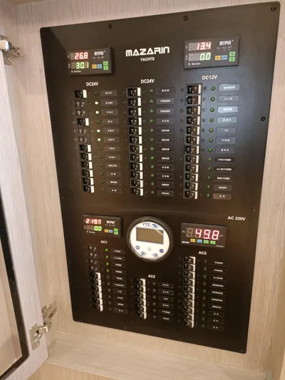  Yacht Photos Pics Electrical control panel of 2022 Mazarin 55 Catamaran, featuring various switches and digital displays.