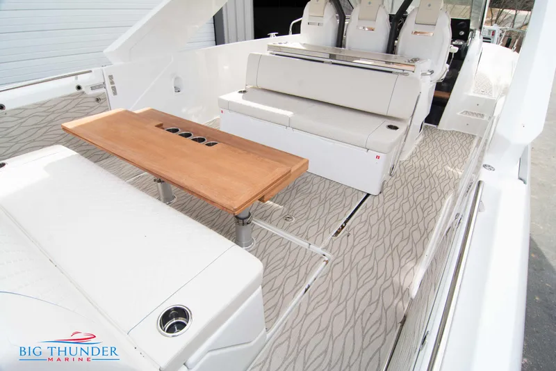 Yacht Photos Pics 2024 Jeanneau DB/37 OB boat interior with seating and wooden table.