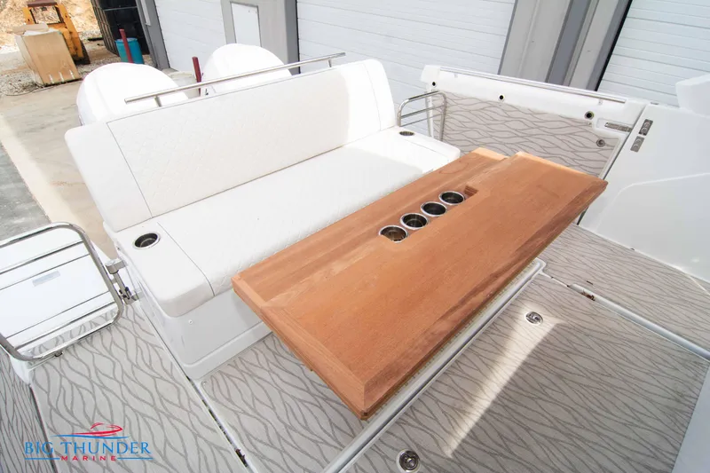  Yacht Photos Pics 2024 Jeanneau DB/37 OB boat interior with white seating and wooden table.