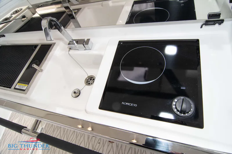  Yacht Photos Pics 2024 Jeanneau DB/37 OB boat kitchen with sink and induction cooktop.