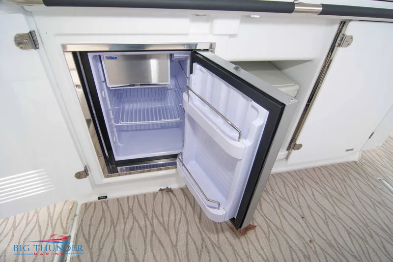  Yacht Photos Pics 2024 Jeanneau DB/37 OB boat interior with open refrigerator.