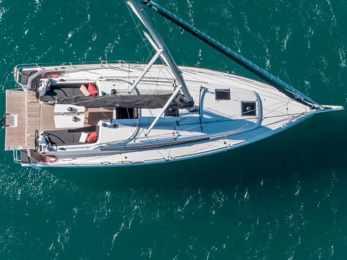  Yacht Photos Pics Aerial view of 2025 Jeanneau 380 sailboat on turquoise water.