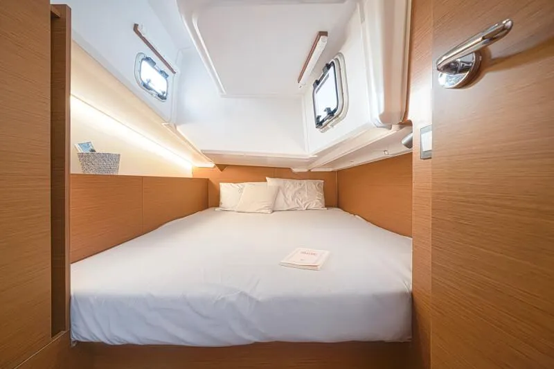  Yacht Photos Pics Luxurious cabin interior of 2025 Jeanneau 380 yacht with cozy bed and modern design.