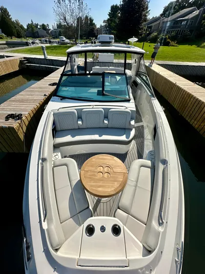  Yacht Photos Pics 2021 Sea Ray SLX 400 Outboard boat with spacious seating and wooden table.