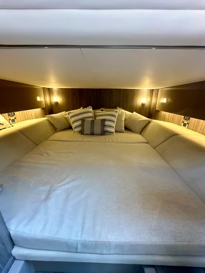 Yacht Photos Pics Luxurious cabin interior of 2021 Sea Ray SLX 400 Outboard with cozy bedding.