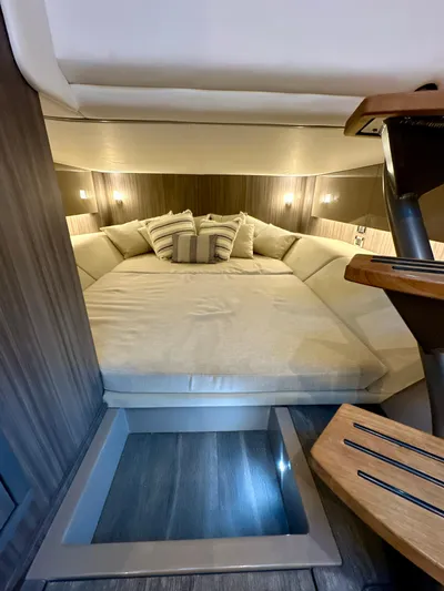  Yacht Photos Pics 2021 Sea Ray SLX 400 Outboard cabin interior with cozy bed and ambient lighting.