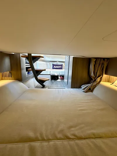  Yacht Photos Pics Interior cabin of 2021 Sea Ray SLX 400 Outboard with cozy bedding and modern design.