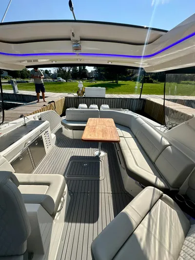  Yacht Photos Pics 2021 Sea Ray SLX 400 Outboard interior with spacious seating and wooden table.