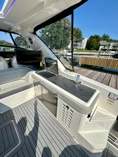  Yacht Photos Pics 2021 Sea Ray SLX 400 Outboard interior with sleek kitchenette and waterfront view.