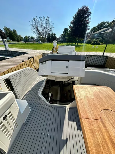  Yacht Photos Pics 2021 Sea Ray SLX 400 Outboard boat interior with wooden table and seating area.