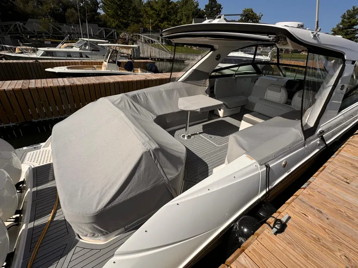  Yacht Photos Pics 2021 Sea Ray SLX 400 Outboard boat docked, featuring covered seating and sleek design.