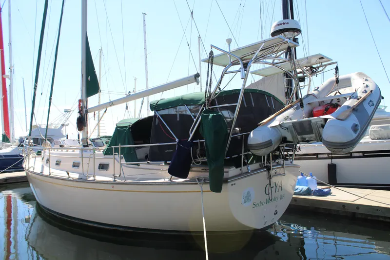  Yacht Photos Pics 1994 Island Packet 40 sailboat docked with dinghy attached, featuring green canvas covers.