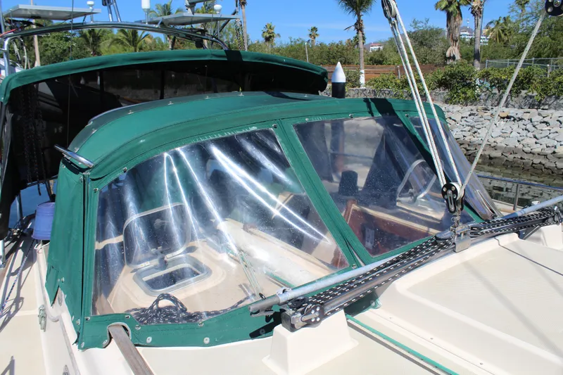  Yacht Photos Pics Sailboat cockpit with green canvas cover, Island Packet 40, 1994 model, docked near palm trees.