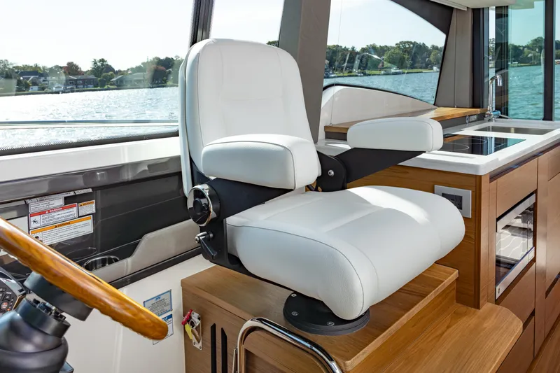  Yacht Photos Pics Captain's chair in 2025 Tiara Yachts 43 LE, overlooking serene waters.