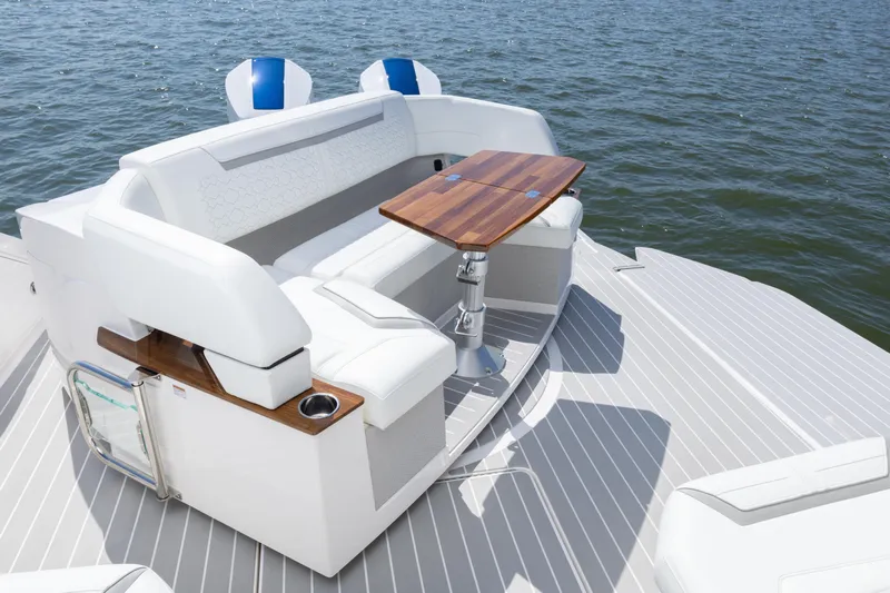  Yacht Photos Pics 2025 Tiara Yachts 43 LE luxury boat seating area with wooden table on water.