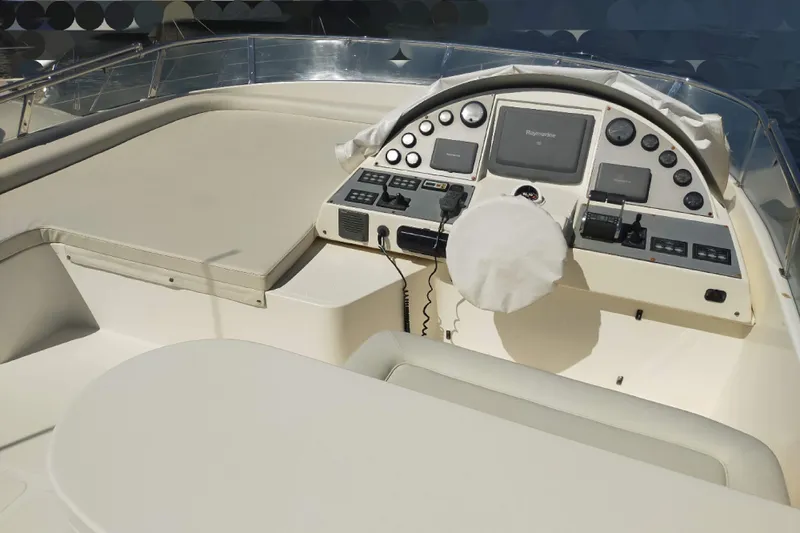  Yacht Photos Pics Cockpit of 2007 Aicon 64 yacht with navigation controls and seating area.