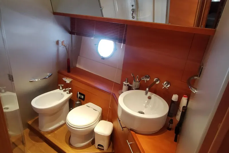  Yacht Photos Pics Luxurious 2007 Aicon 64 yacht bathroom with modern fixtures and porthole window.