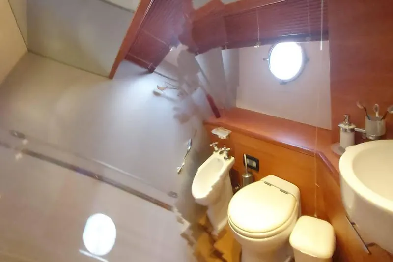  Yacht Photos Pics Bathroom interior of 2007 Aicon 64 yacht with porthole and modern fixtures.