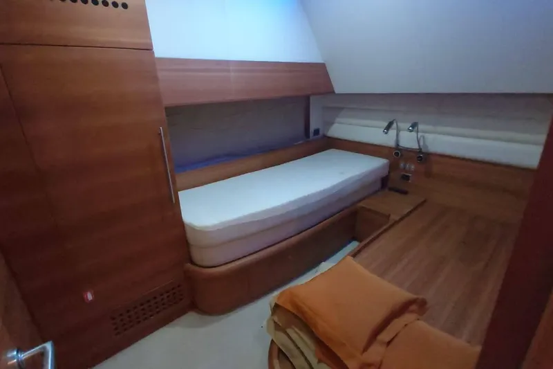  Yacht Photos Pics Luxurious cabin interior of 2007 Aicon 64 yacht with wooden furnishings and cozy bed.