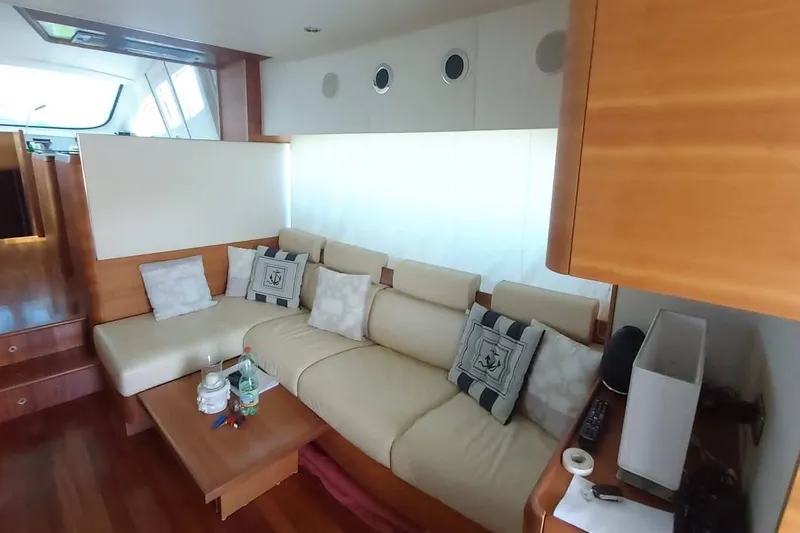  Yacht Photos Pics Luxurious interior of 2007 Aicon 64 yacht with cream leather seating and nautical decor.