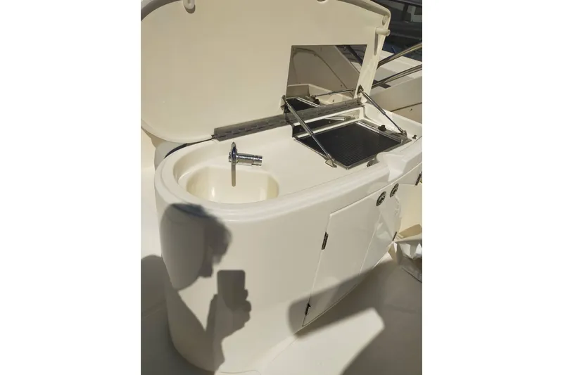  Yacht Photos Pics 2007 Aicon 64 yacht kitchenette with sink and grill in sunlight.