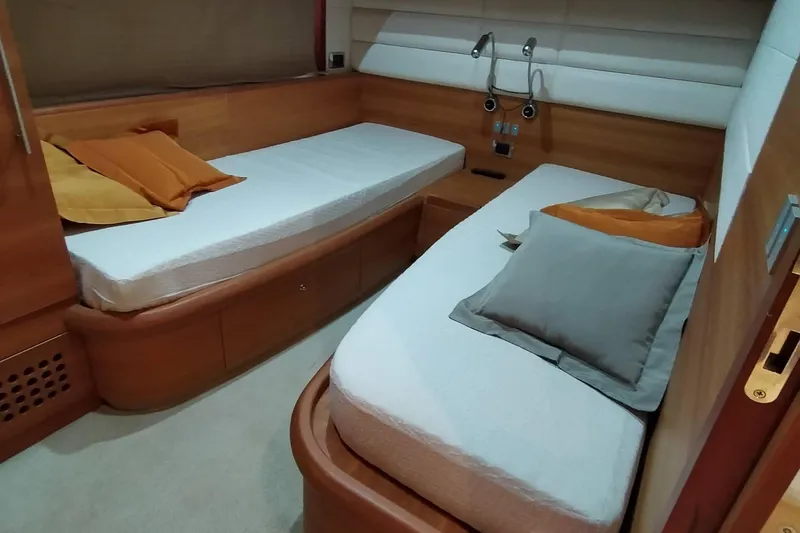  Yacht Photos Pics Interior of 2007 Aicon 64 yacht cabin with twin beds and wooden finish.