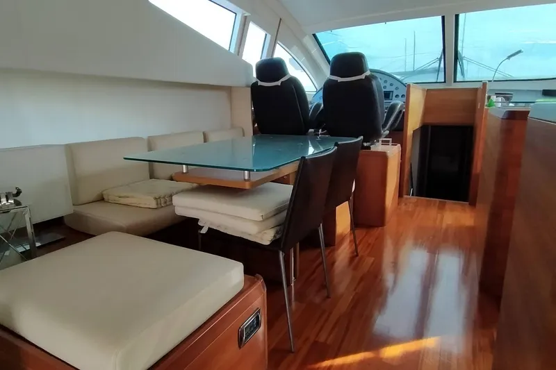  Yacht Photos Pics Luxurious interior of 2007 Aicon 64 yacht with elegant seating and glass table.