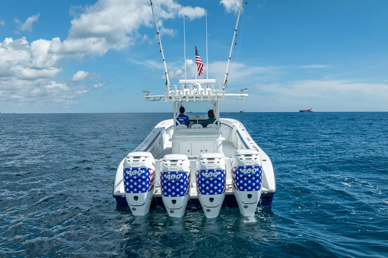  Yacht Photos Pics 2023 Yellowfin 39 Offshore boat with four engines on open sea under blue sky.