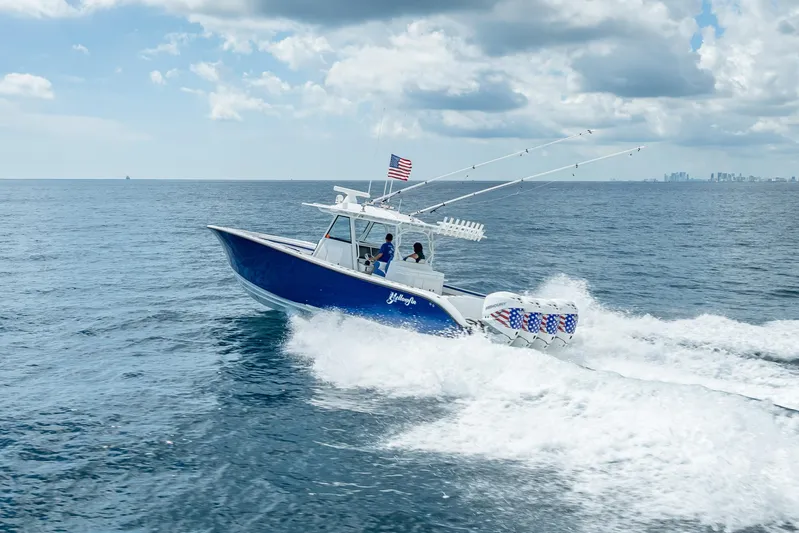  Yacht Photos Pics 2023 Yellowfin 39 Offshore boat cruising on open ocean under cloudy sky.
