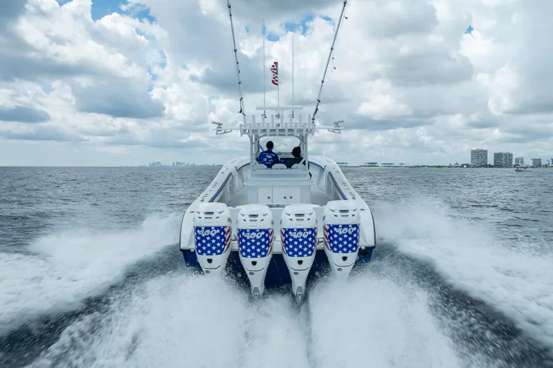  Yacht Photos Pics 2023 Yellowfin 39 Offshore boat speeding on open water under cloudy sky.