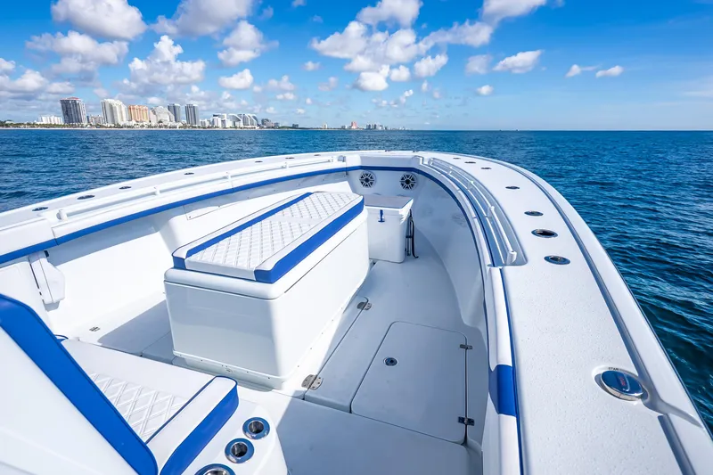  Yacht Photos Pics 2023 Yellowfin 39 Offshore boat on ocean with city skyline in background.