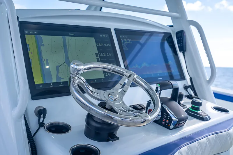  Yacht Photos Pics Control panel of 2023 Yellowfin 39 Offshore boat with navigation screens and steering wheel.