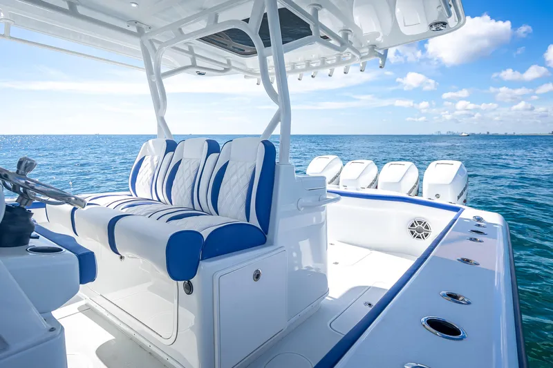  Yacht Photos Pics 2023 Yellowfin 39 Offshore boat interior with blue and white seating, ocean view.