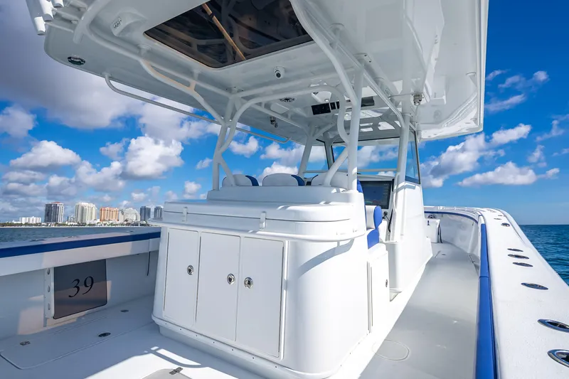  Yacht Photos Pics 2023 Yellowfin 39 Offshore boat on open water, clear sky, city skyline in background.