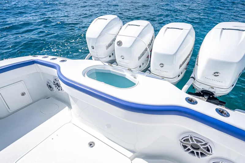  Yacht Photos Pics 2023 Yellowfin 39 Offshore boat with four powerful outboard engines on blue ocean water.