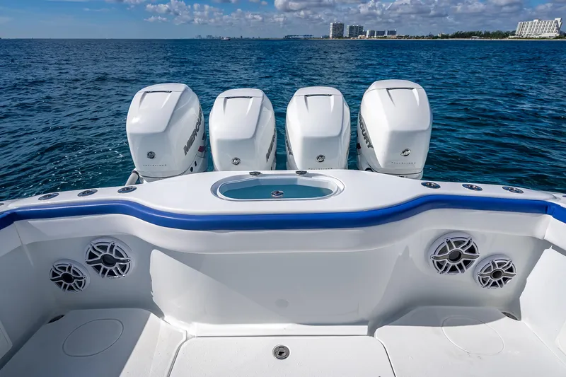  Yacht Photos Pics 2023 Yellowfin 39 Offshore boat with four powerful outboard engines on open sea.