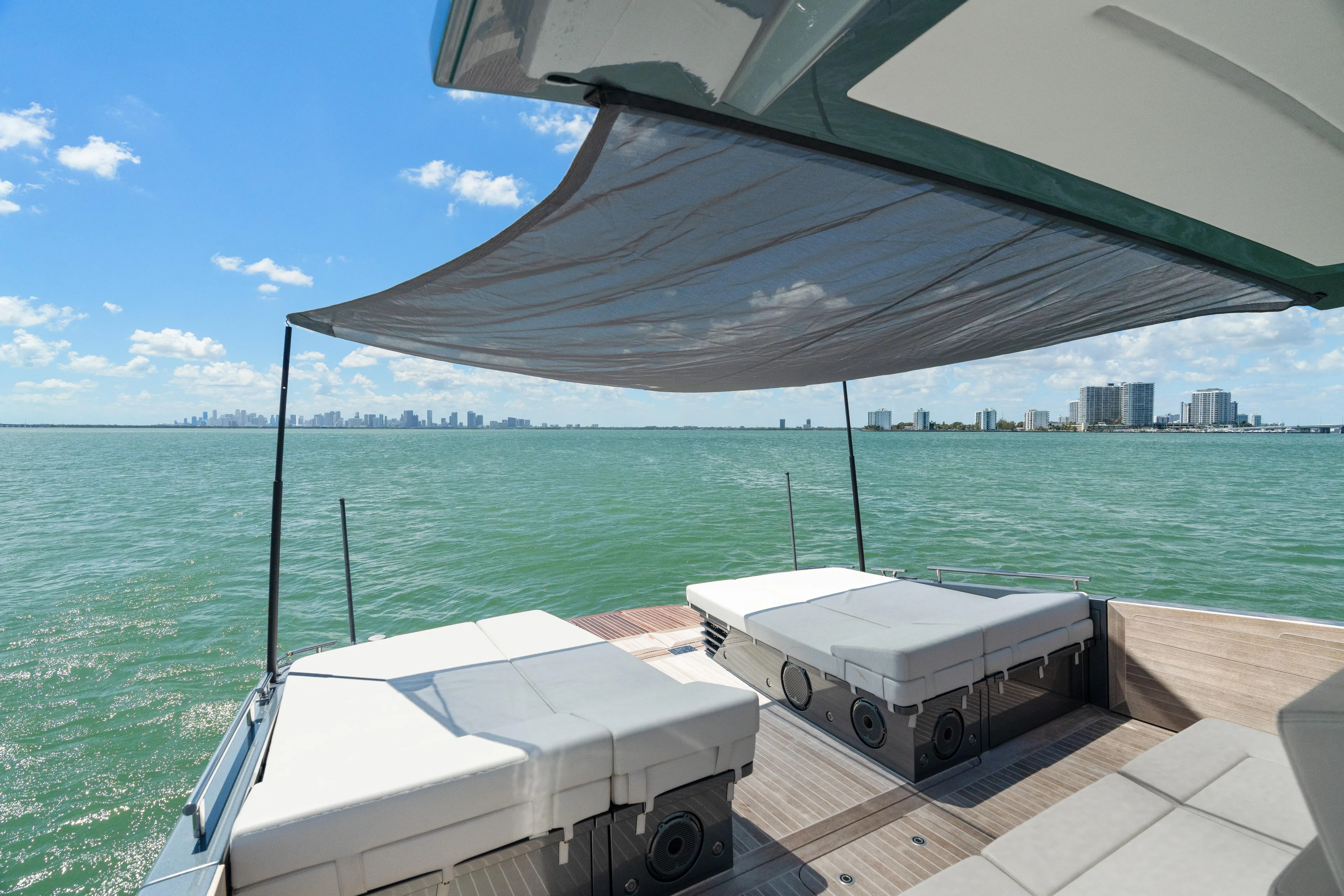 Pura Vida Yacht Photos Pics Luxurious 2024 CNM CONTINENTAL 54 SuperSport yacht with sunbeds and canopy on open water.